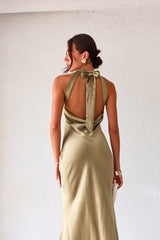 Take your style to the next level with the MAIN EVENT SATIN MAXI DRESS! This luxurious dress features a high neckline and adjustable tie in the back, perfect for creating a flattering silhouette. The draped back adds a touch of elegance to complete your look. Dress to impress with this stunning piece.