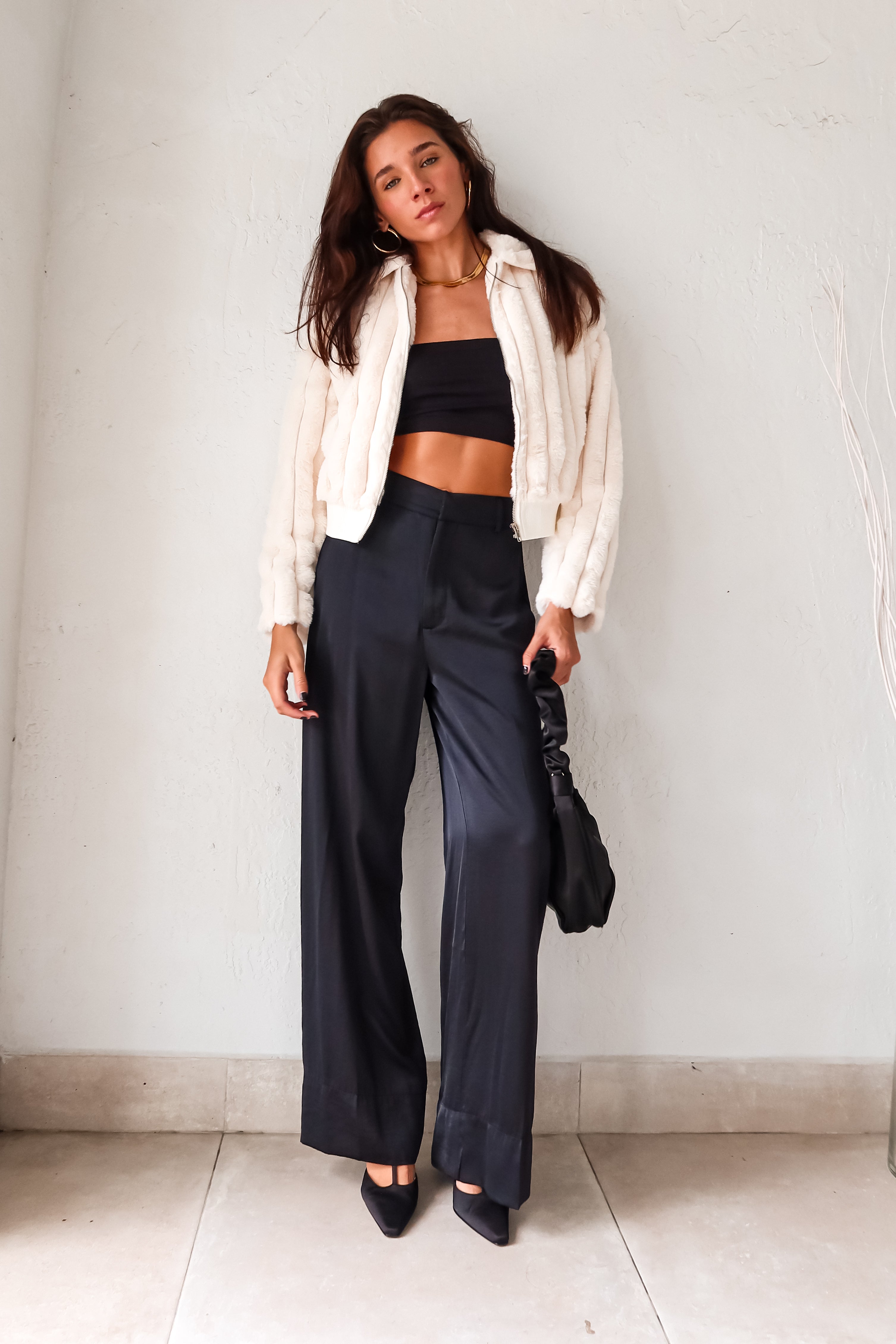 Slip into sleek style with the MONTMARTRE TROUSER in black. These satin trousers feature a zipper clip closure and elastic waist backing for a comfortable fit. With front pockets and belt loops, this pant is both functional and fashionable. Elevate your look with this versatile and chic piece!