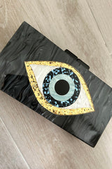 Keep your style on point with our EVIL EYE ACRYLIC CLUTCH. Made from sleek black marble acrylic, this clutch features a mesmerizing evil eye design. The removable shoulder chain adds versatility and allows you to rock the clutch in different ways.