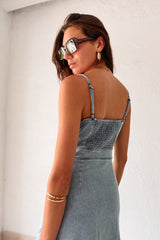 Get ready to rock a laid-back look with our Cypress Denim Midi Dress. This versatile piece features a front button down closure and adjustable shoulder straps for a customizable fit. The stretchy fabric and smocked backing provide ultimate comfort, while the chest stitch detail adds a touch of unique style. Non lined for a lightweight feel.