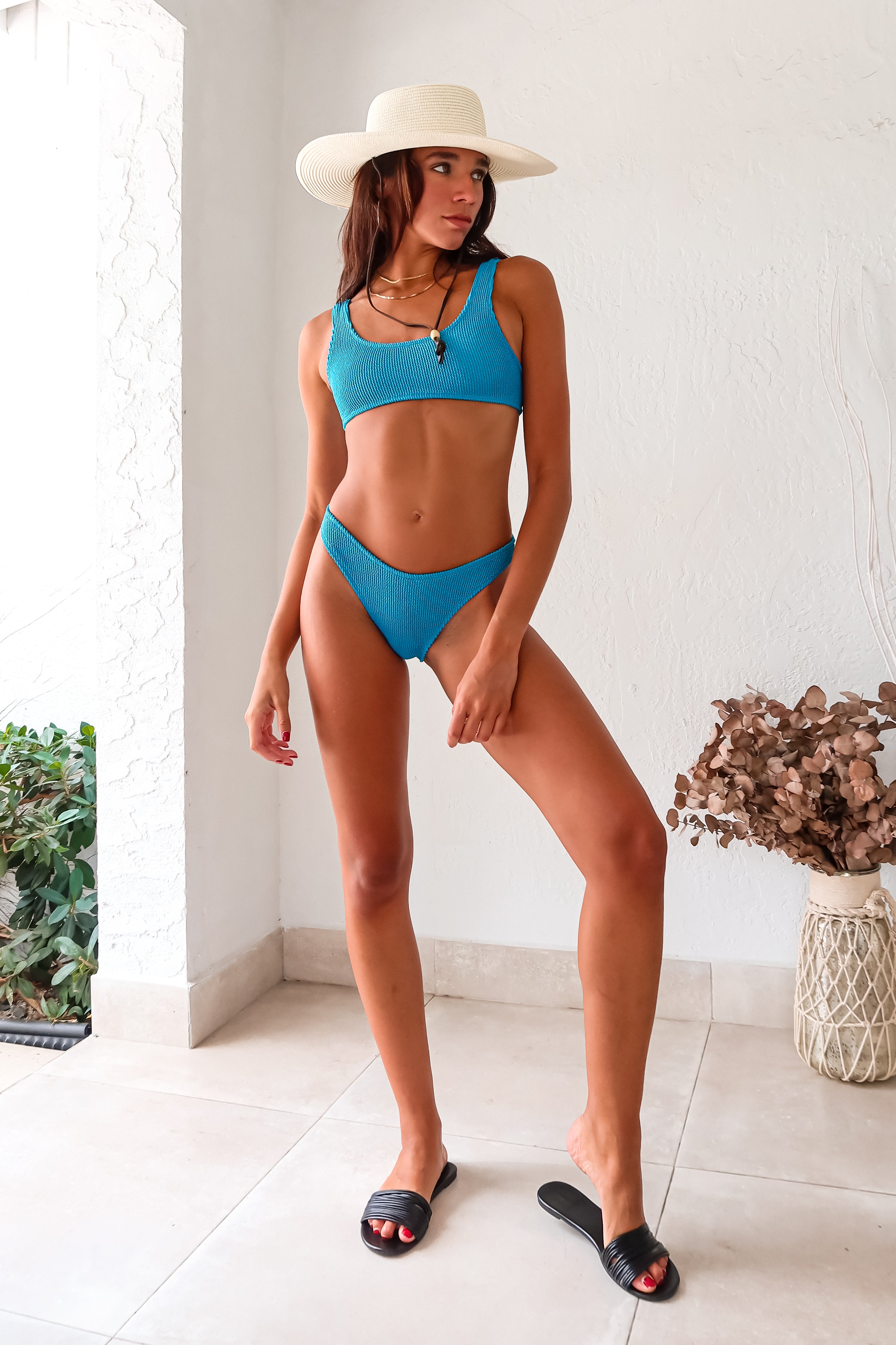 Make a splash in our OJAI ONE SIZE BIKINI SET! Featuring a sky blue crinkle design, this set is perfect for sizes S-L. The sporty bra style top offers a lift, while the moderate coverage bottoms can be worn high or low. Handcrafted in Miami by Alila Swim.