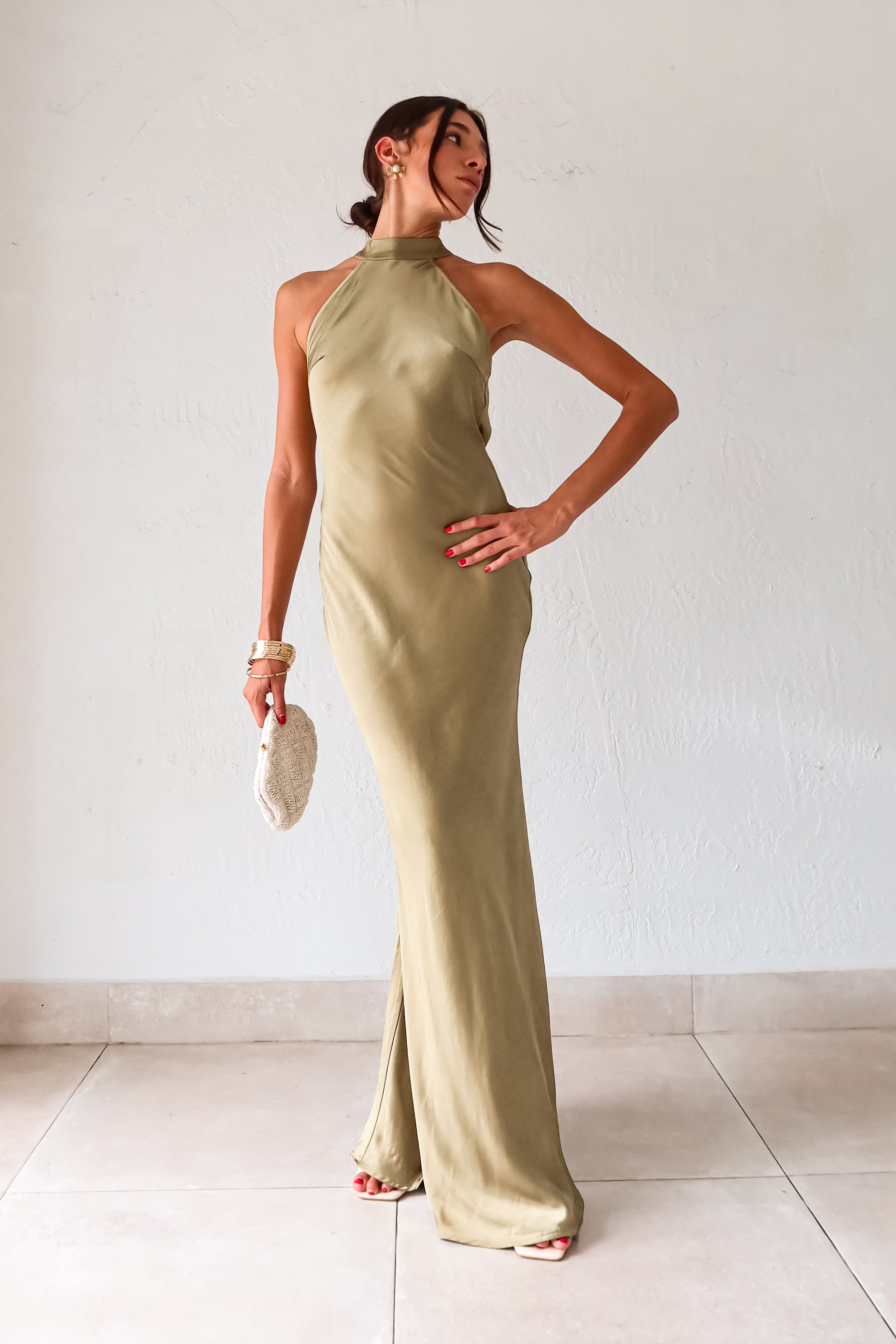 Take your style to the next level with the MAIN EVENT SATIN MAXI DRESS! This luxurious dress features a high neckline and adjustable tie in the back, perfect for creating a flattering silhouette. The draped back adds a touch of elegance to complete your look. Dress to impress with this stunning piece.