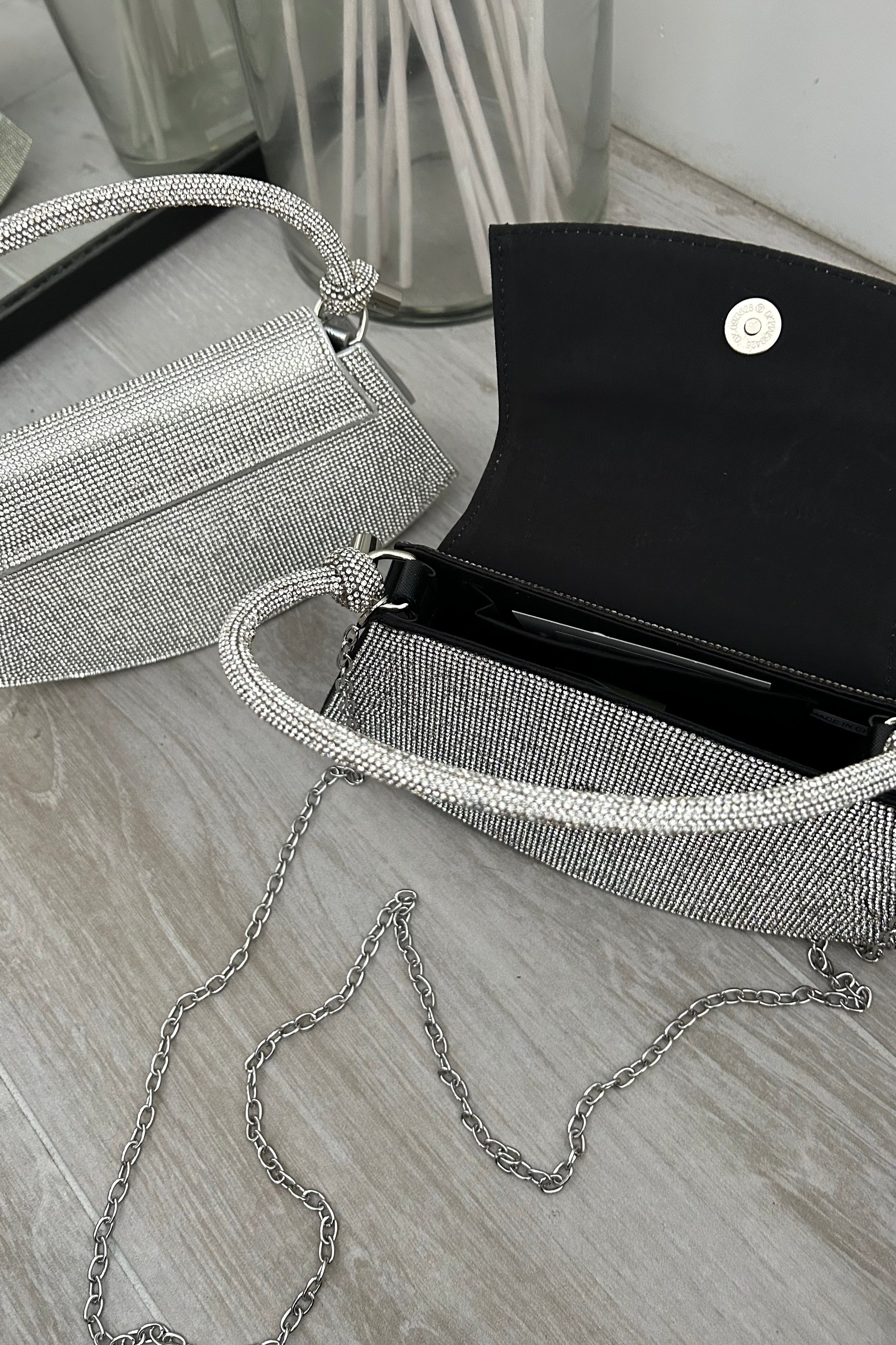 Enhance your glitz and glam with this Vegas rhinestone bag! Featuring a front clip closure and removable shoulder strap, this silver handbag will add the perfect touch of sparkle to any outfit. Perfect for a night out on the town or a special event, this bag is sure to be a showstopper.