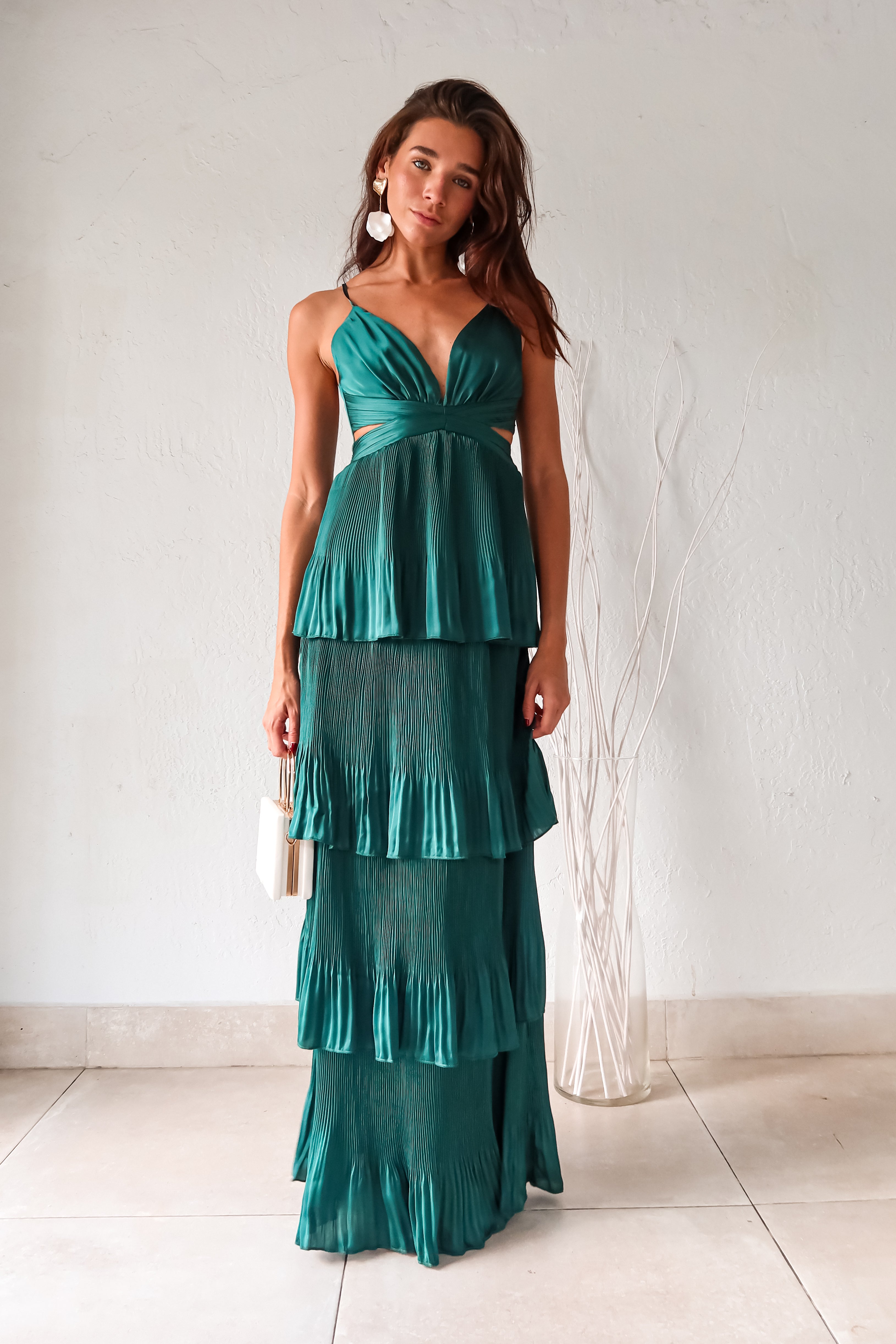 Turn heads in the PARISIAN GARDEN SATIN MAXI DRESS. With an emerald green satin fabric, adjustable shoulder straps, and a back zipper closure, this dress is both comfortable and stunning. The chiffon overlap detail adds a touch of elegance to this playful and chic piece.