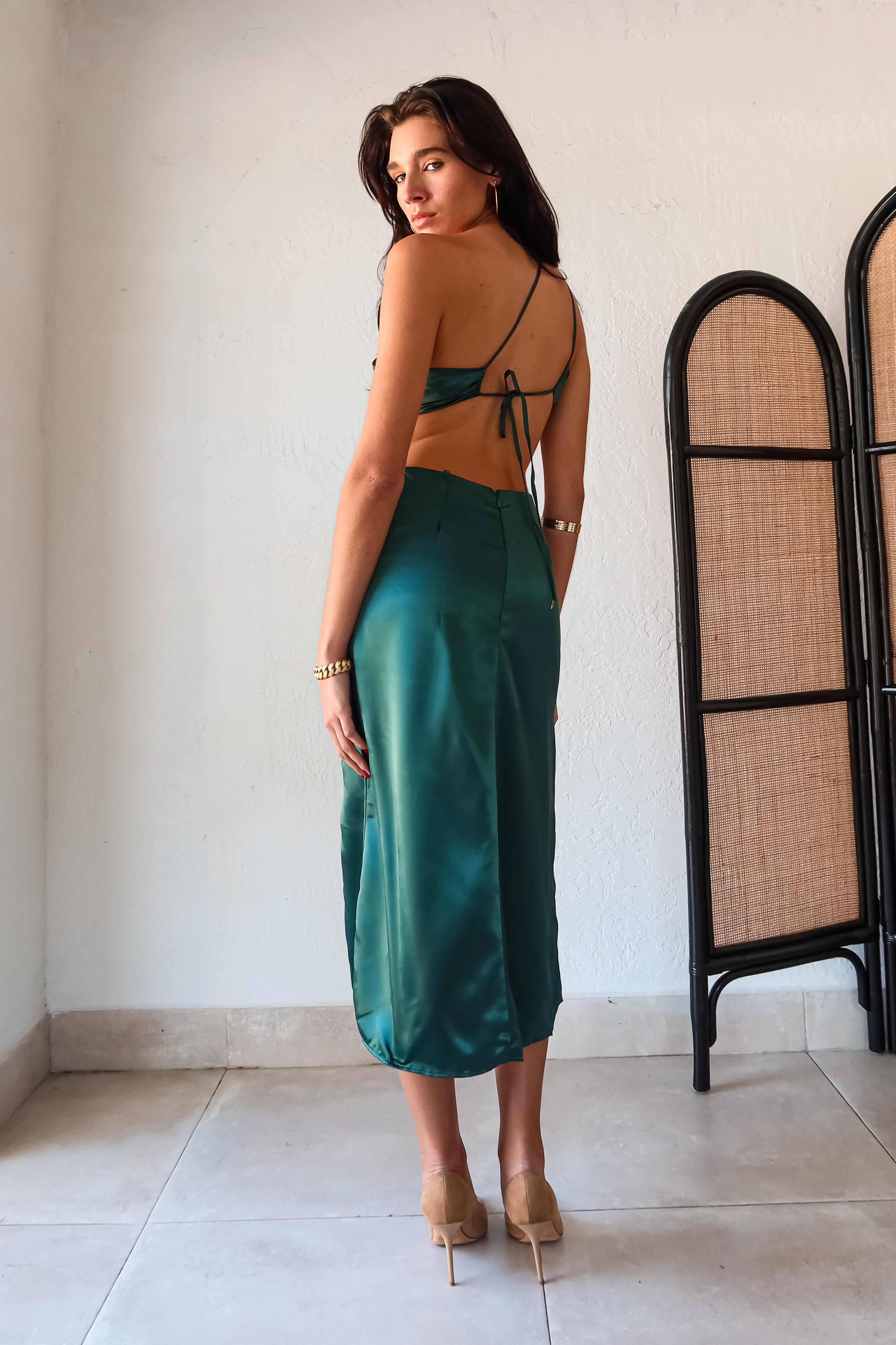 Get ready to slay at cocktail hour with this jewel green satin maxi dress! The one shoulder top with a knot detail adds a touch of glamour, while the left leg slit shows off your killer legs. Ties around back keep the look secure, and a bottom zipper closure makes getting dressed a breeze.