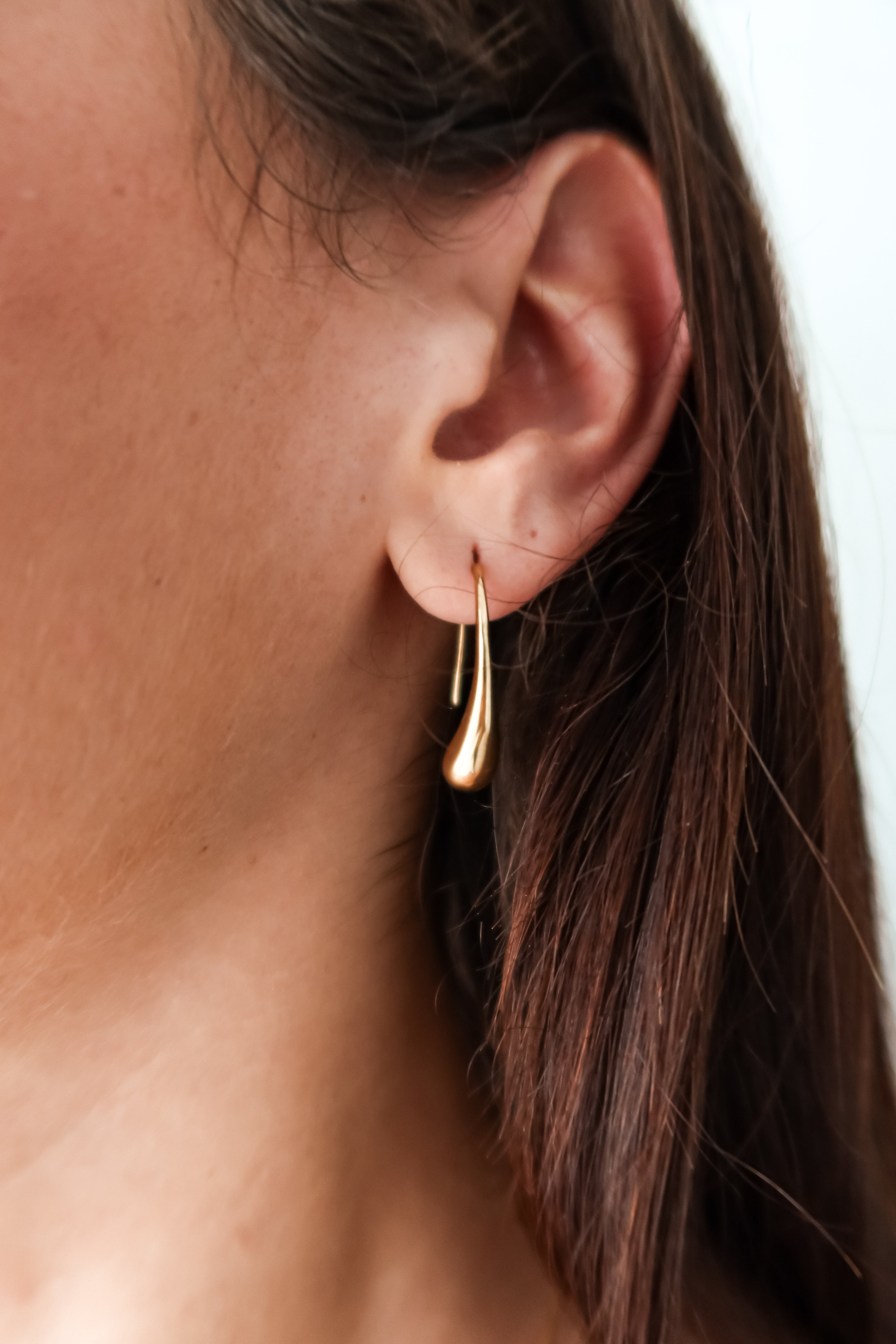 Add a touch of whimsy to your ensemble with these ST Teardrop Earrings. Made of gold plated over sterling silver, these 1 inch length earrings feature a teardrop design that is both elegant and playful. Plus, they are tarnish resistant and hypoallergenic for worry-free wear.