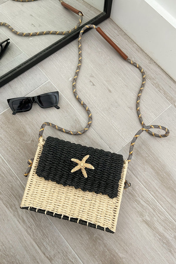 Add a touch of beachy glam with our Positano Bag. The beige and black squared handbag features a gold starfish detail and a unique rope design shoulder strap. Perfectly paired with our Melrose Linen Maxi dress. Snap buckle closure adds convenience and style.