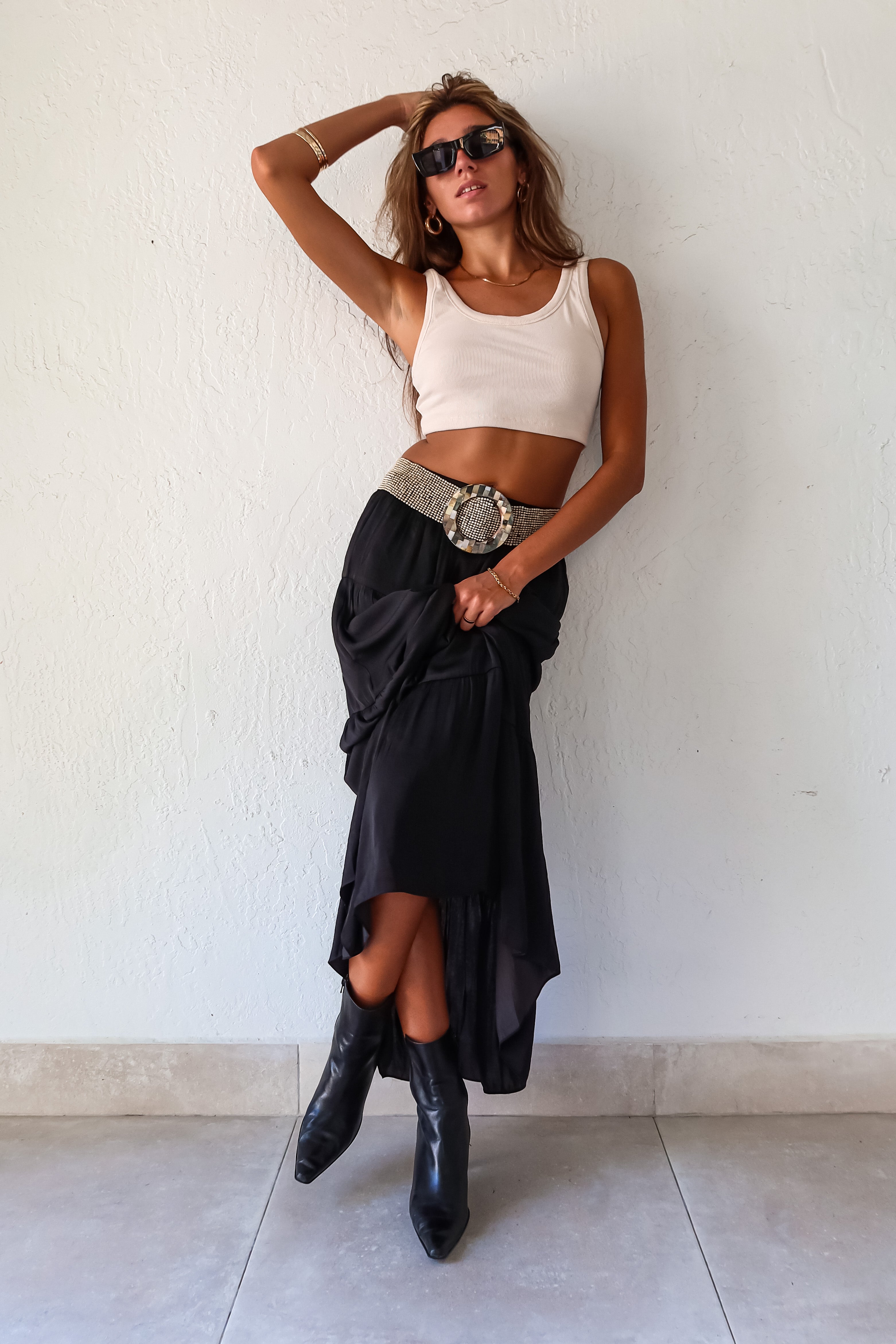  elegance and edge to your wardrobe with the Venus Satin Maxi Skirt in black! The non-stretch satin fabric flows beautifully while the elastic waistband provides a comfortable and flattering fit. Fully lined for a luxe feel 