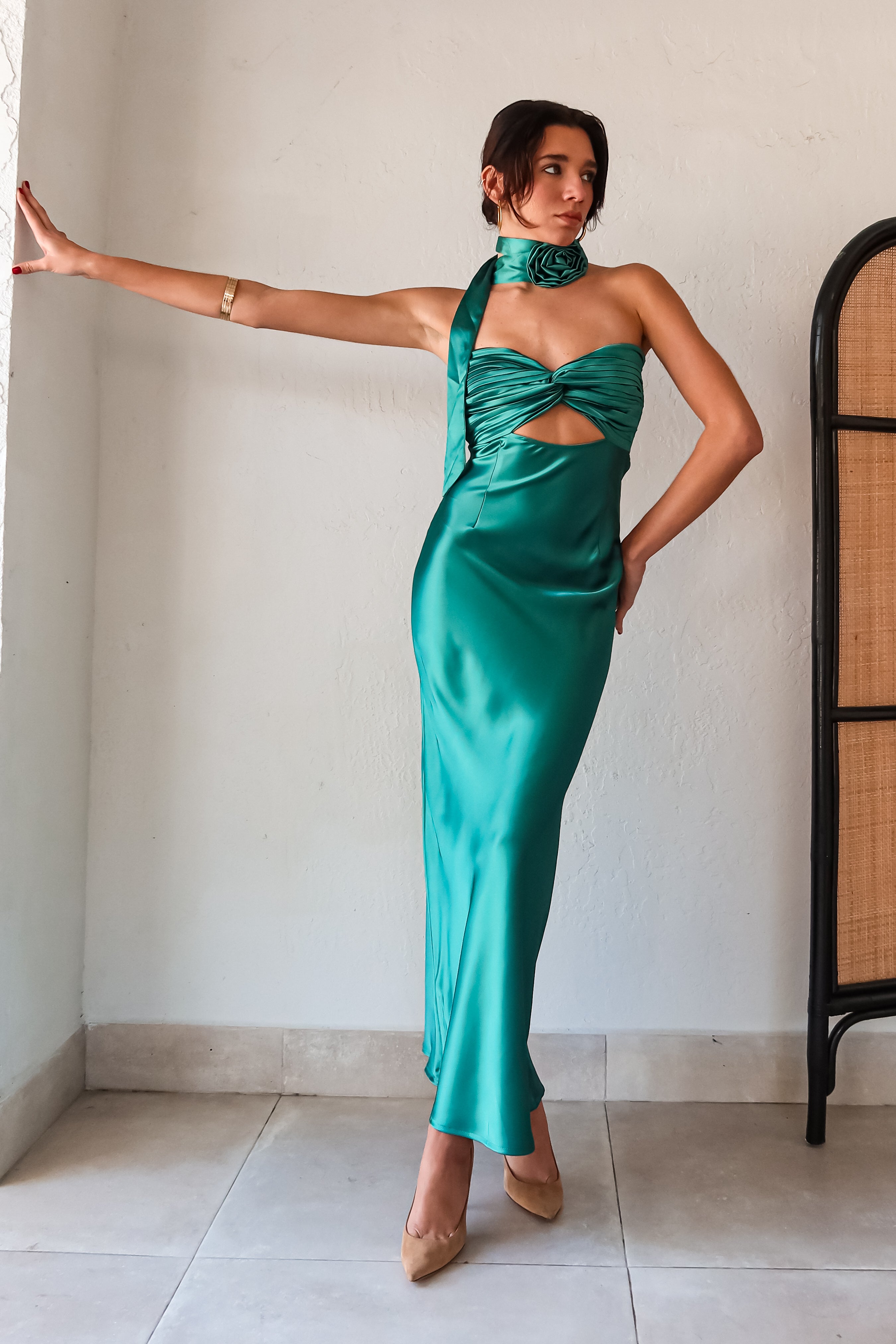 The LE FLEUR SATIN MAXI is a jewel green dress that will have you shining like a gem. Its strapless design features a pleated twisted bust, adding a touch of elegance. For a unique look, the optional flower choker scarf can be added. The open back detailing and side zipper closure make for easy wear. Get ready to turn heads in this stunning dress!