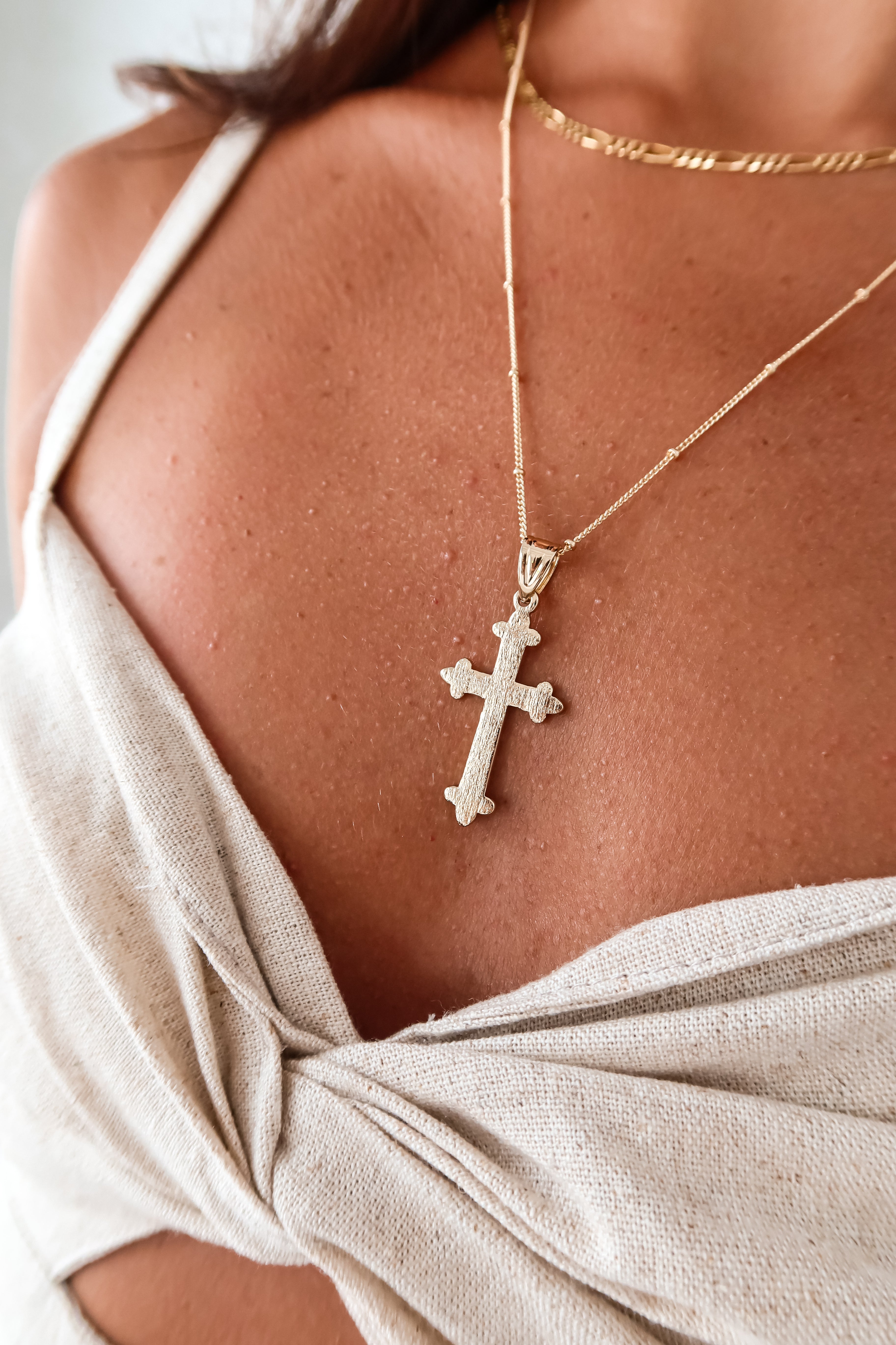 Get ready to make a statement with our Texture Cross Long Necklace! Made with gold-plated 925 stainless steel, this 11-inch necklace is not only stylish, but also tarnish-resistant and hypoallergenic. Pair it with our Sole Linen Pant set for a flawless look.