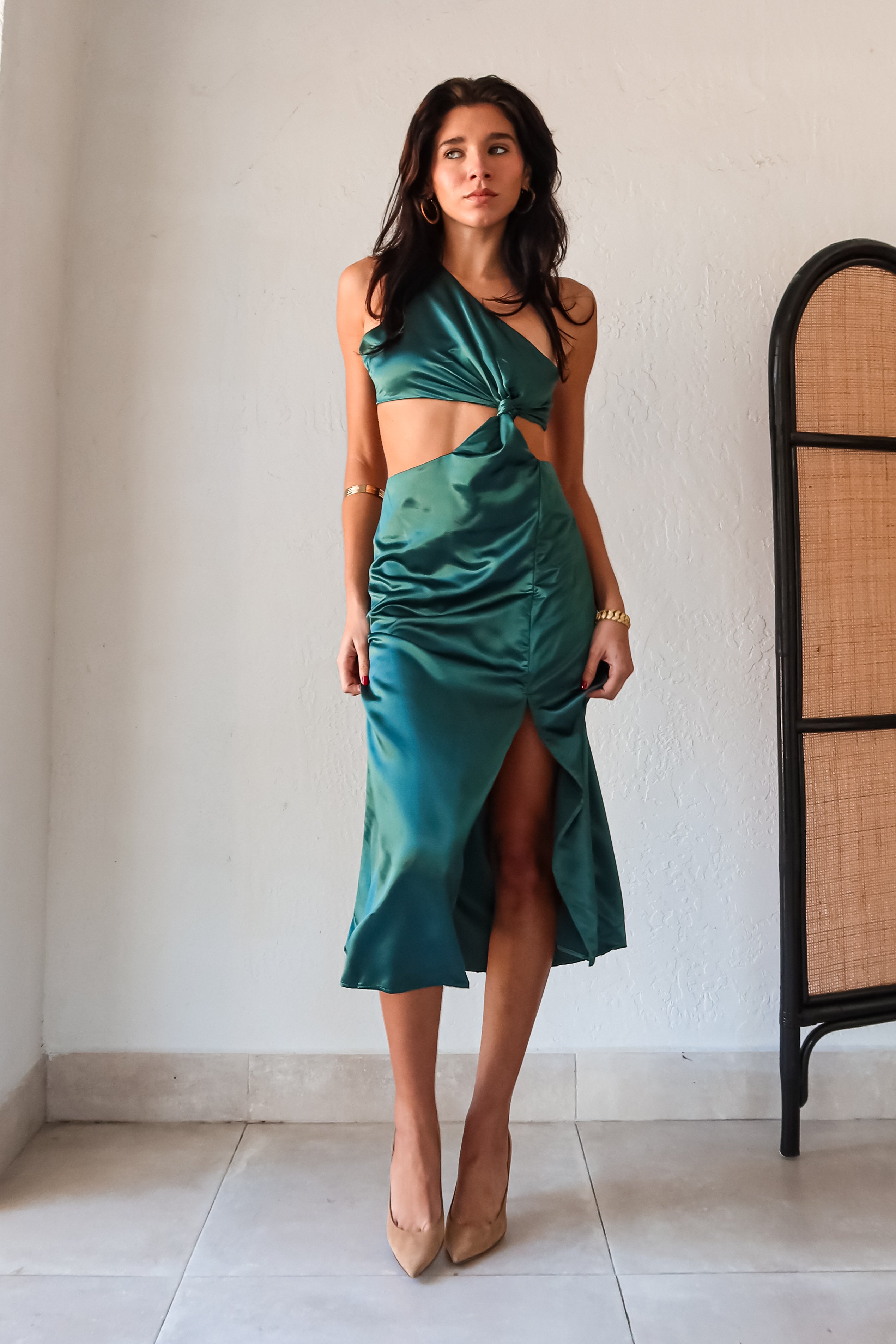 Get ready to slay at cocktail hour with this jewel green satin maxi dress! The one shoulder top with a knot detail adds a touch of glamour, while the left leg slit shows off your killer legs. Ties around back keep the look secure, and a bottom zipper closure makes getting dressed a breeze.