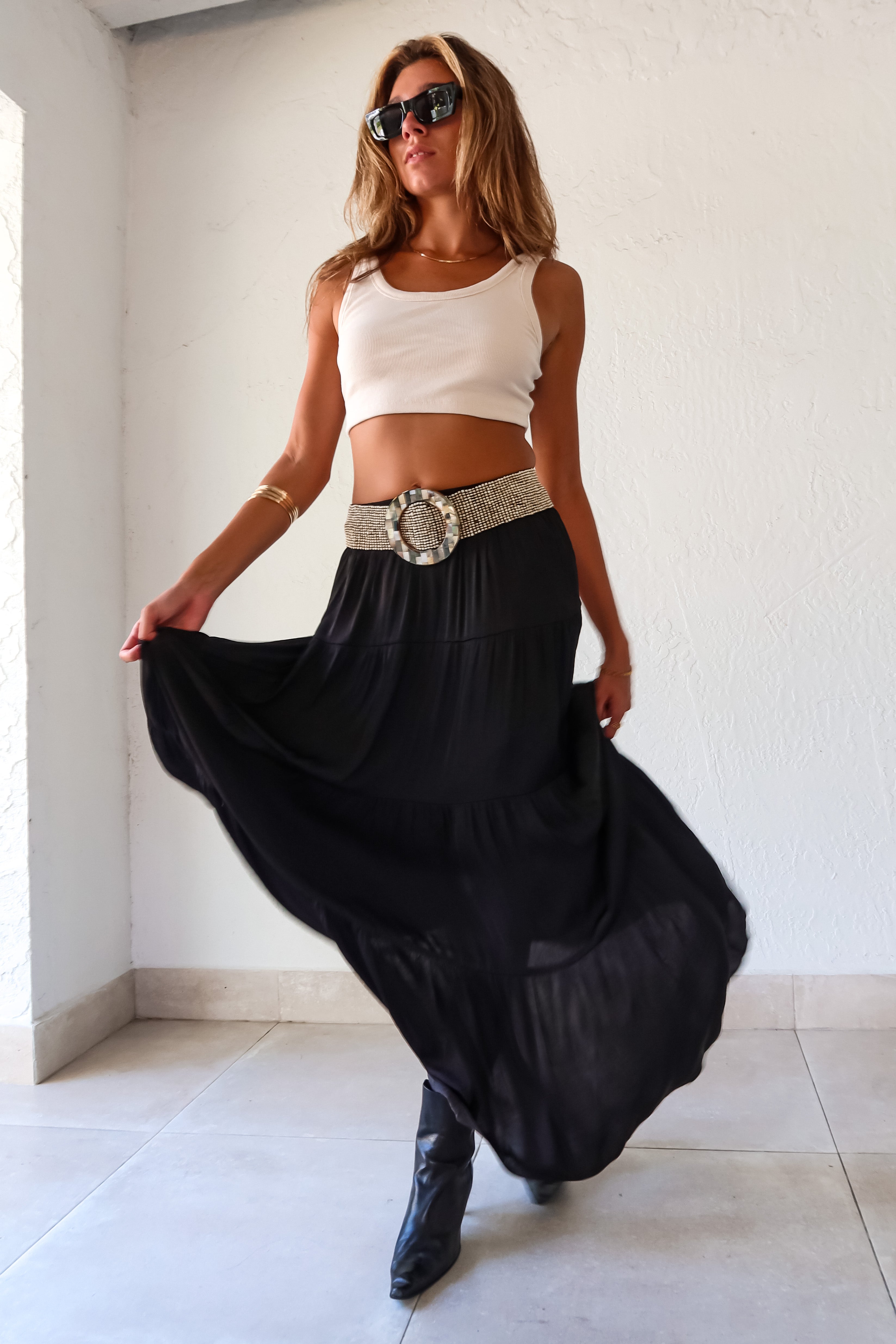  elegance and edge to your wardrobe with the Venus Satin Maxi Skirt in black! The non-stretch satin fabric flows beautifully while the elastic waistband provides a comfortable and flattering fit. Fully lined for a luxe feel 