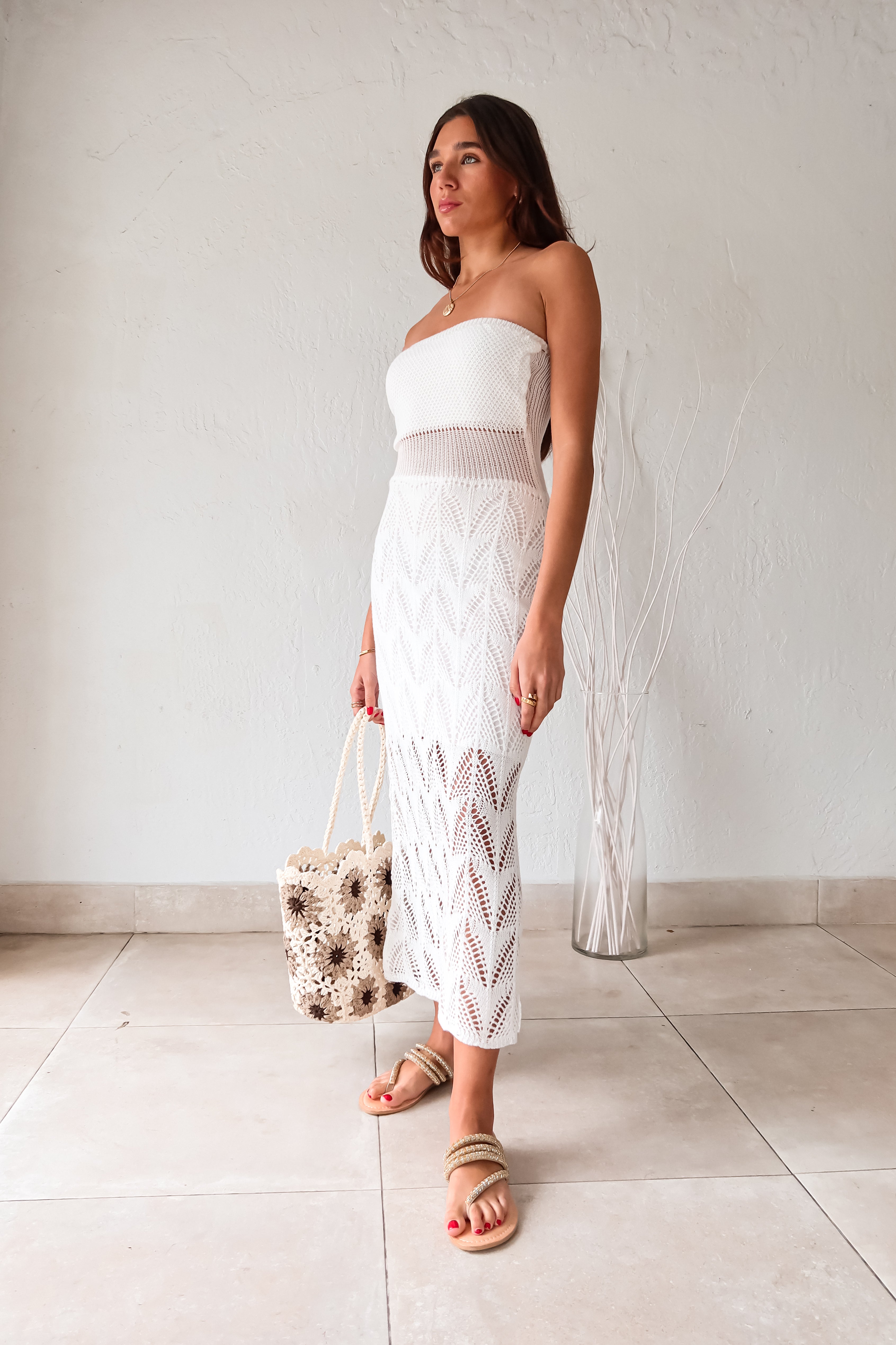 Get ready to turn heads in our TROPICAL NEW YEAR CROCHET MAXI! This white crochet maxi dress features a strapless design and a sheer torso for a touch of allure. Don't worry about coverage, it's lined (except the torso) for your comfort. Plus, it's stretchy for a perfect fit!