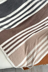 Stay cozy and stylish with our Striped Microfiber Blanket! Made of 100% polyester microfiber, this white blanket with navy, khaki, and brown stripes is perfect for snuggling up on chilly nights. Measures 50x60 inches. Upgrade your comfort game now!