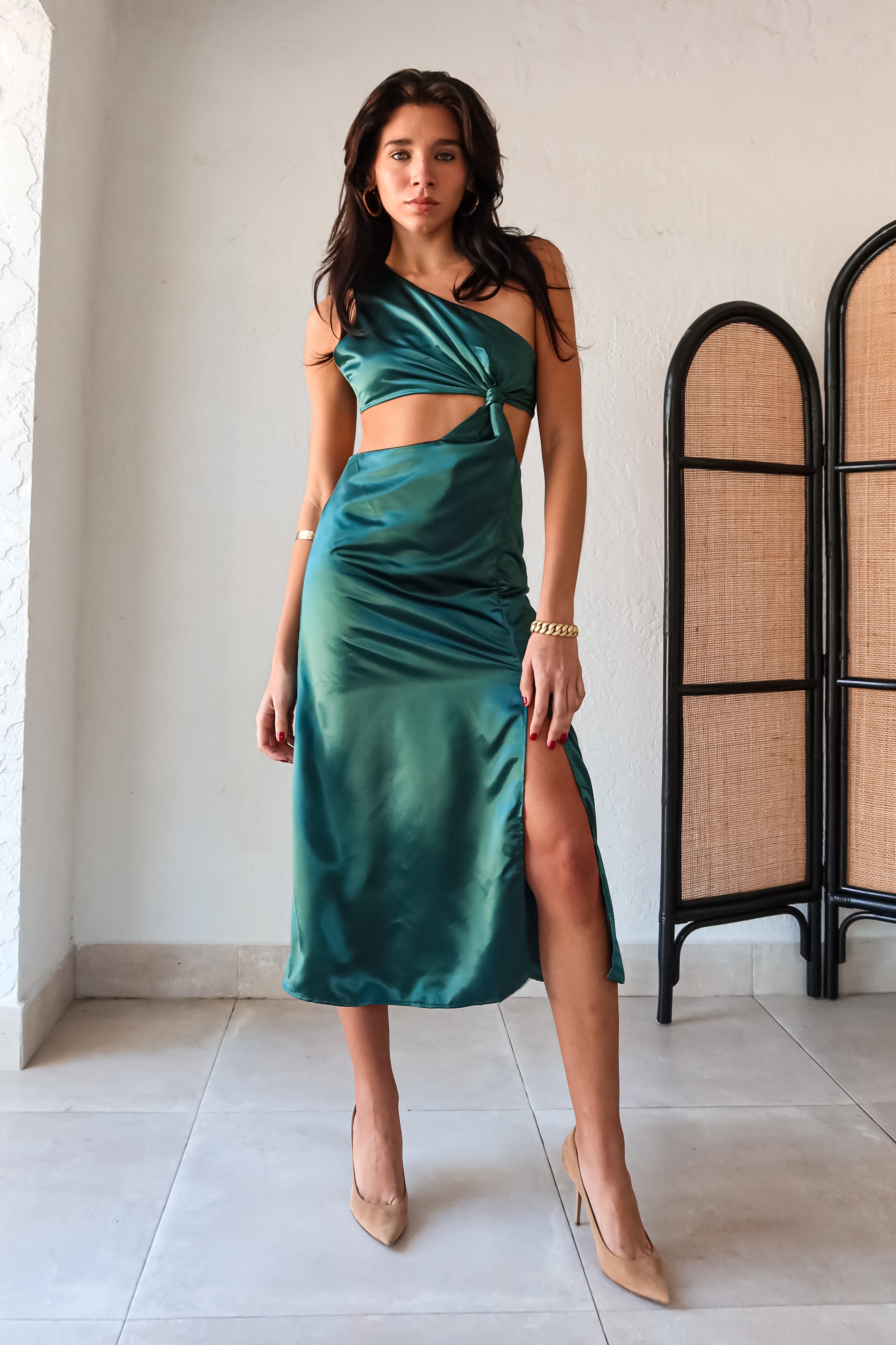 Get ready to slay at cocktail hour with this jewel green satin maxi dress! The one shoulder top with a knot detail adds a touch of glamour, while the left leg slit shows off your killer legs. Ties around back keep the look secure, and a bottom zipper closure makes getting dressed a breeze.