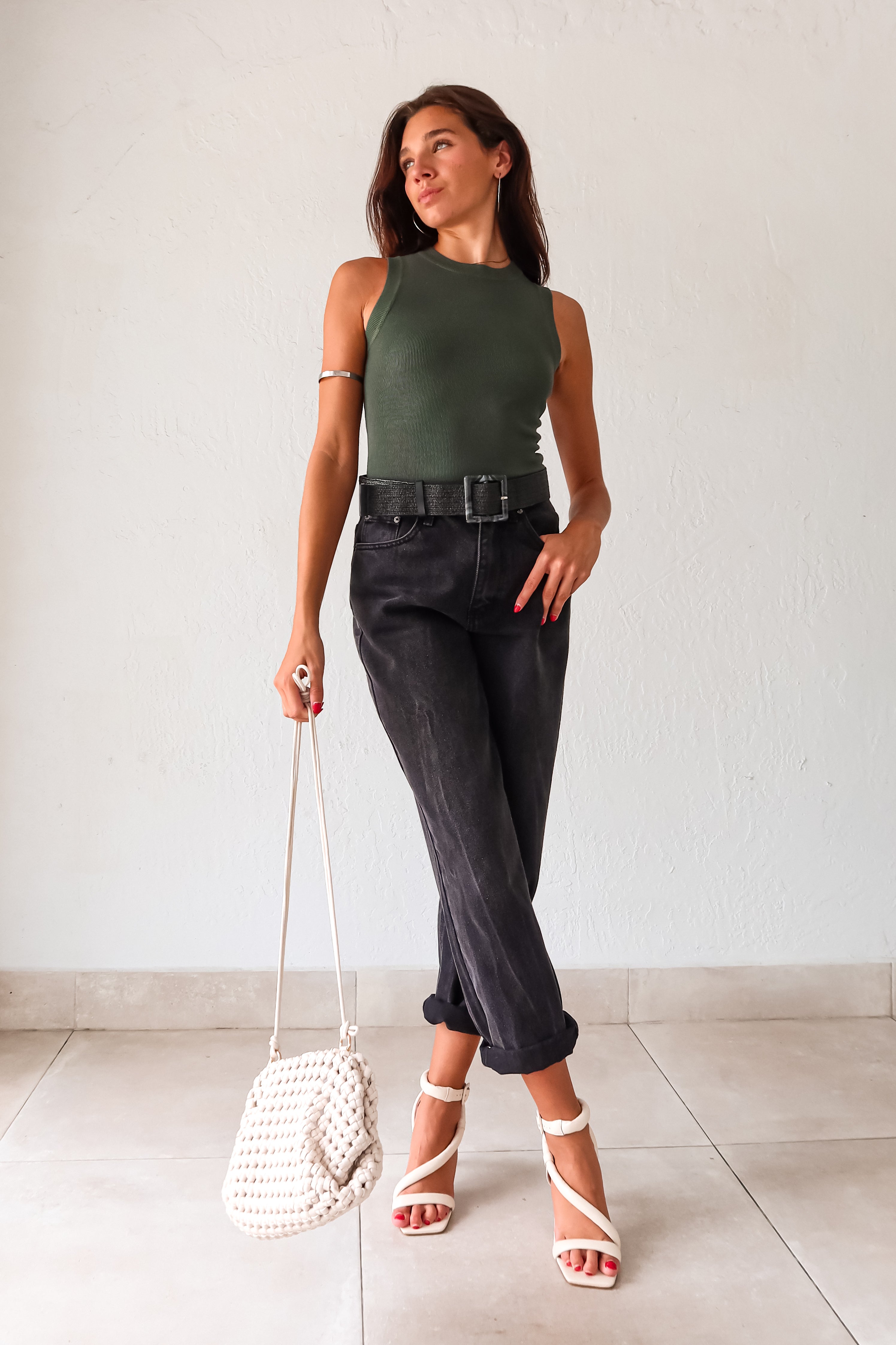 Get ready to elevate your wardrobe with our DRESS IT UP KNIT TANK in hunter green. This ribbed neck tank top is perfect for any occasion and runs big, so size down for the perfect fit. Non-lined and non-stretch, it's easy to care for- just hand wash cold. Pair it with our Marbled Stretch belt and the Grecia Woven Purse for a chic look.