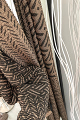 Add some shimmer to your outfit with our IKAT LUREX SHAWL! The metallic lurex thread adds a touch of glamour to the traditional ikat print. Available in black and brown, this shawl is the perfect accessory for a fun and quirky touch to any outfit.