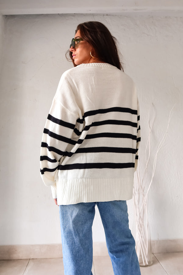 Get ready to groove with our Grove Walk Striped Sweater! This white and black striped sweater features ribbed wrist and waistline for a comfortable and customizable fit. With stretchy fabric and one size fitting XS-L, this sweater is perfect for any occasion.