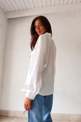 Put a playful twist on your classic work attire with our GABLES LONG SLEEVE BLOUSE. This white, non-lined button down blouse is both lightweight and comfortable for all-day wear. With long sleeves and button wrists, this blouse is perfect for any season. Don't settle for boring office wear, stand out in style!