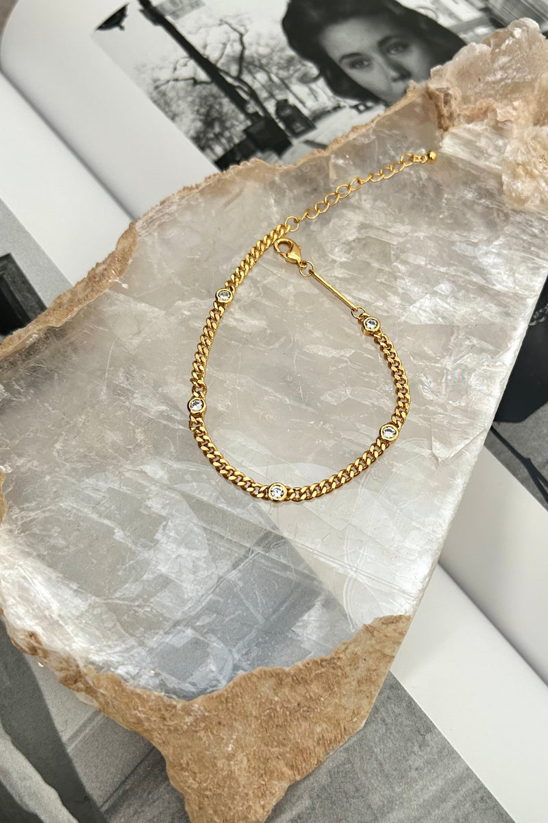 This dainty bracelet is a charming addition to any outfit. Made with a gold plated over sterling silver, it features a sparkling gem detail that adds a touch of elegance. Plus, it's tarnish resistant and hypoallergenic, ensuring a long-lasting and comfortable wear. A perfect choice for those looking for both style and practicality.