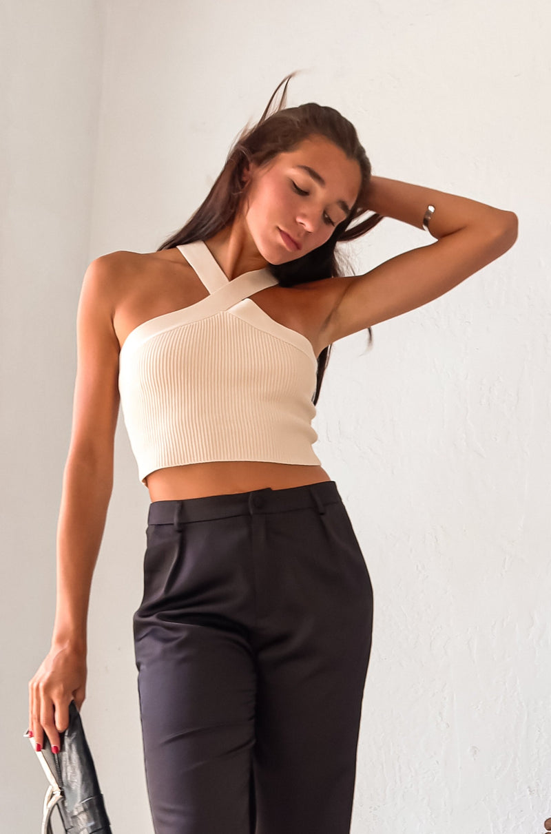 Add a touch of fun to your wardrobe with our Crossroads Knit Top in Cream! This ribbed crop top features a unique X cross design in both the front and back, made with a thick and stretchy luxe ribbed fabric for a comfortable fit. Dress it up or down, day or night, and feel effortlessly stylish!