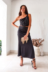 BRODEUX SATIN SKIRT SET - BLACK! This quirky set features a one-shoulder bubble crop top with a front twist detail and a side zipper closure, paired with a midi skirt that has a comfortable elastic band in the back. Non-stretch, lined top and non-lined bottom for maximum comfort.