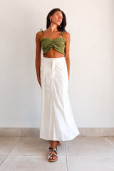 Get ready to turn heads in our ARCADIA SMART CROP TOP! This playful olive green crop top features a criss cross front design and smocked fabric, providing a comfortable stretchy fit. With ruffled edges and adjustable shoulder straps, this non-lined top is perfect for a fun night out! Pair with the Misommar Linen Maxi Skirt for a complete look.