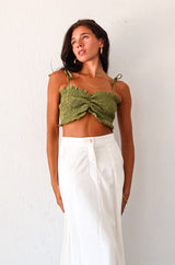 Get ready to turn heads in our ARCADIA SMART CROP TOP! This playful olive green crop top features a criss cross front design and smocked fabric, providing a comfortable stretchy fit. With ruffled edges and adjustable shoulder straps, this non-lined top is perfect for a fun night out! Pair with the Misommar Linen Maxi Skirt for a complete look.