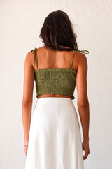 Get ready to turn heads in our ARCADIA SMART CROP TOP! This playful olive green crop top features a criss cross front design and smocked fabric, providing a comfortable stretchy fit. With ruffled edges and adjustable shoulder straps, this non-lined top is perfect for a fun night out! Pair with the Misommar Linen Maxi Skirt for a complete look.