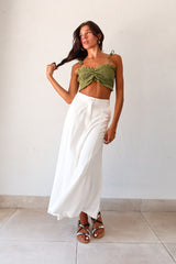 Get ready to turn heads in our ARCADIA SMART CROP TOP! This playful olive green crop top features a criss cross front design and smocked fabric, providing a comfortable stretchy fit. With ruffled edges and adjustable shoulder straps, this non-lined top is perfect for a fun night out! Pair with the Misommar Linen Maxi Skirt for a complete look.