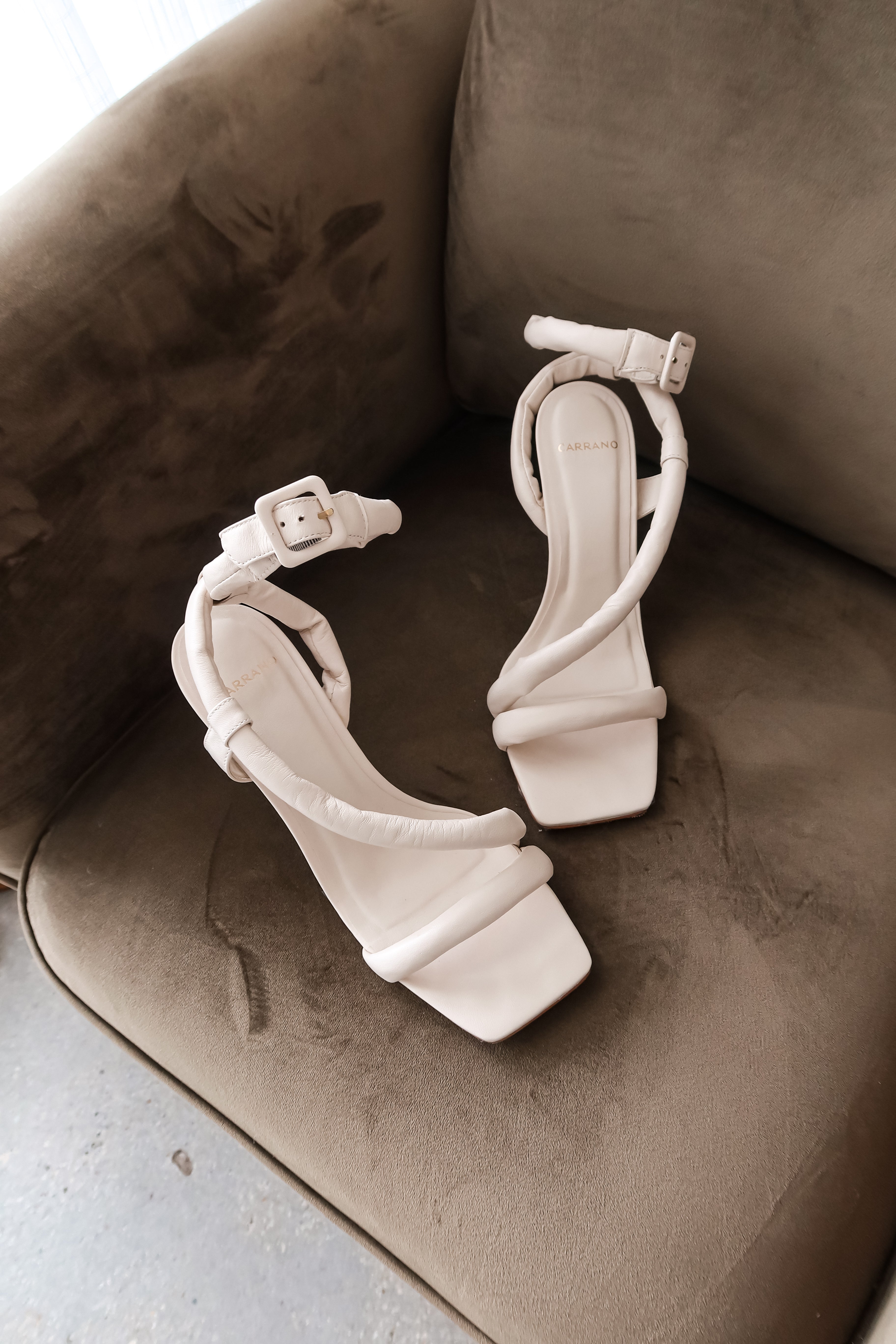 Step up your shoe game with our Puff Strap Leather Heel in White! This cream leather heel features a playful puff strap that adds a touch of elegance to any outfit. Made in Brazil, it's as comfortable as it is stylish with a padded sole and 2 1/3 inch heel. Elevate your style with this unique statement piece!