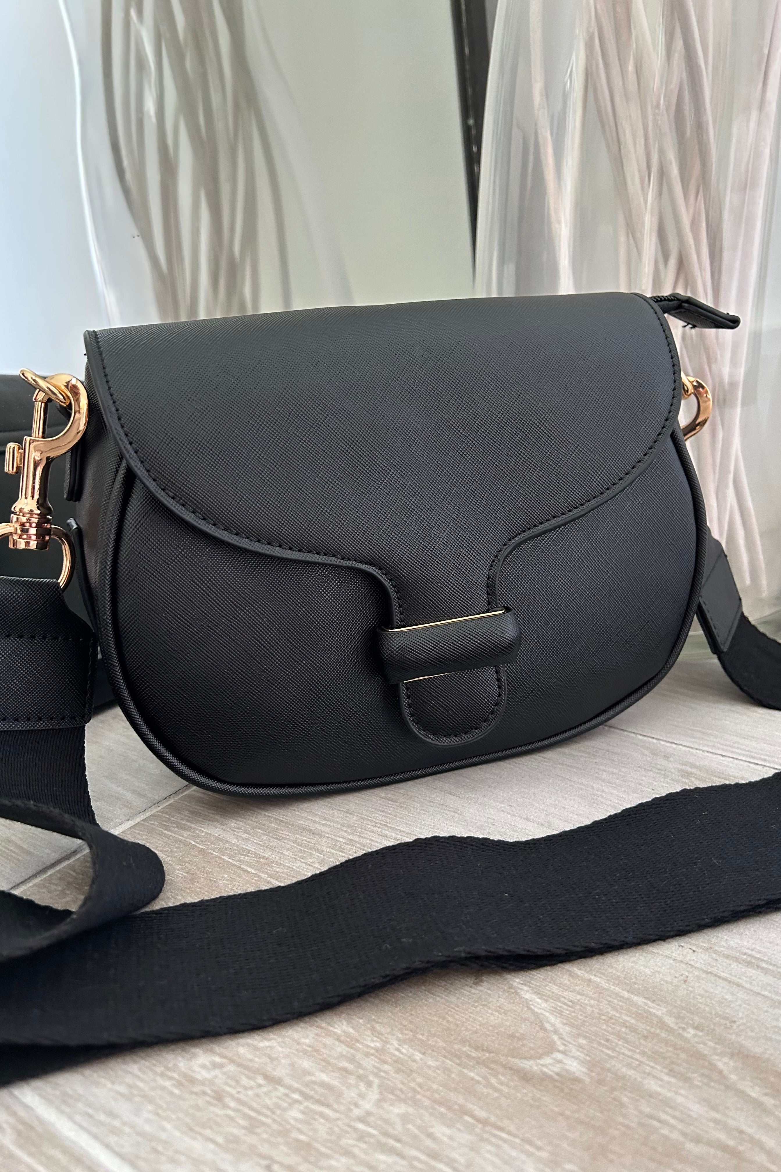 Sling in style with our GRETA TEXTURE CROSSBODY BAG. Made from vegan leather, it features a removable crossbody strap and gold buckle detail. Stay on trend with magnetic and zipper closures. Your perfect carry-all, minus the guilt!