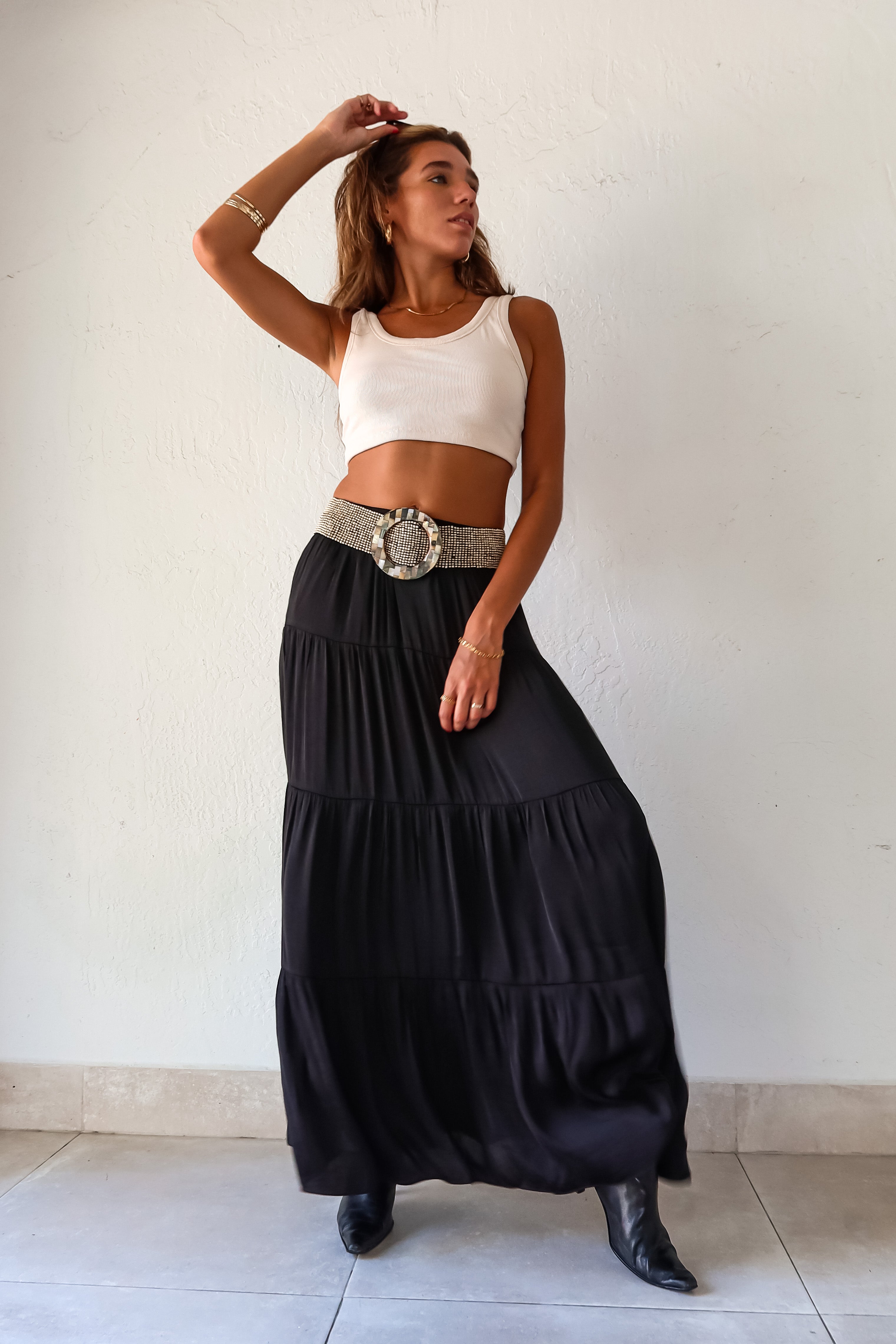  elegance and edge to your wardrobe with the Venus Satin Maxi Skirt in black! The non-stretch satin fabric flows beautifully while the elastic waistband provides a comfortable and flattering fit. Fully lined for a luxe feel 