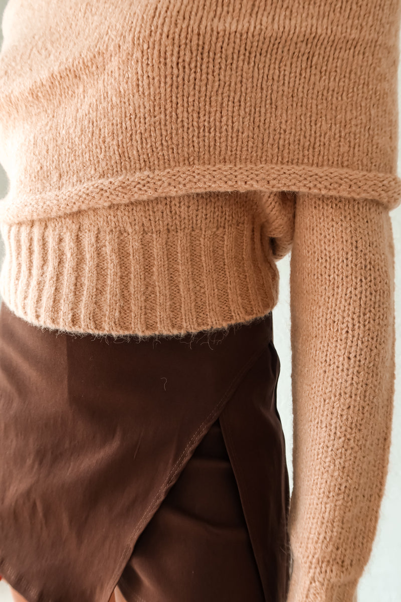 Stay cozy and stylish all season long with our Aspen Sweater! This tan long sleeve sweater features a unique foldover design, ribbed wrist and torso for a snug fit, and stretchy fabric for ultimate comfort. Perfect for any occasion, whether you're out and about or lounging at home.