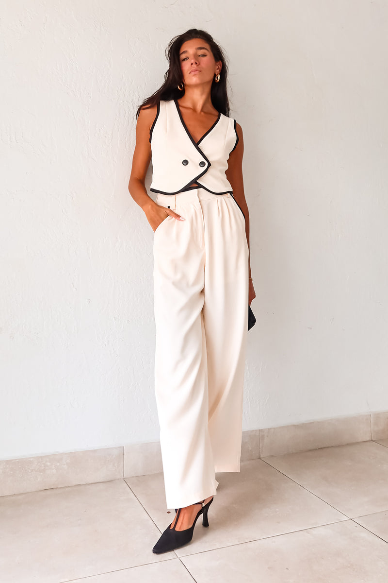 Unleash your inner fashionista with our BAL HARBOUR VEST PANT SET. This cream vest pant set features a unique black lining and an adjustable fit with a back buckle detail. The front button closure top and zipper clip closure pants provide practicality, while the front pockets add a touch of functionality. Sophisticated yet playful, this set will elevate your wardrobe. 