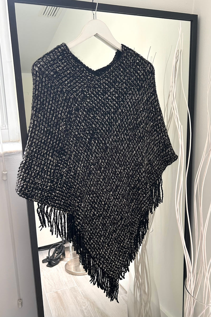 Add a touch of sparkle to your wardrobe with our Full Moon Lurex Poncho! This sequined, stretchy knit top adds just the right amount of glitz to any outfit. Plus, its fringed hem adds playful movement. Choose from two colors: black and khaki.