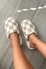 Step up your cozy game with our Checkmate Slippers! These white and khaki checker pattern slippers are not only stylish, but also made with comfy plush fabric for ultimate comfort. The cushioned sole will keep your feet happy all day long. It's game over for uncomfortable slippers!