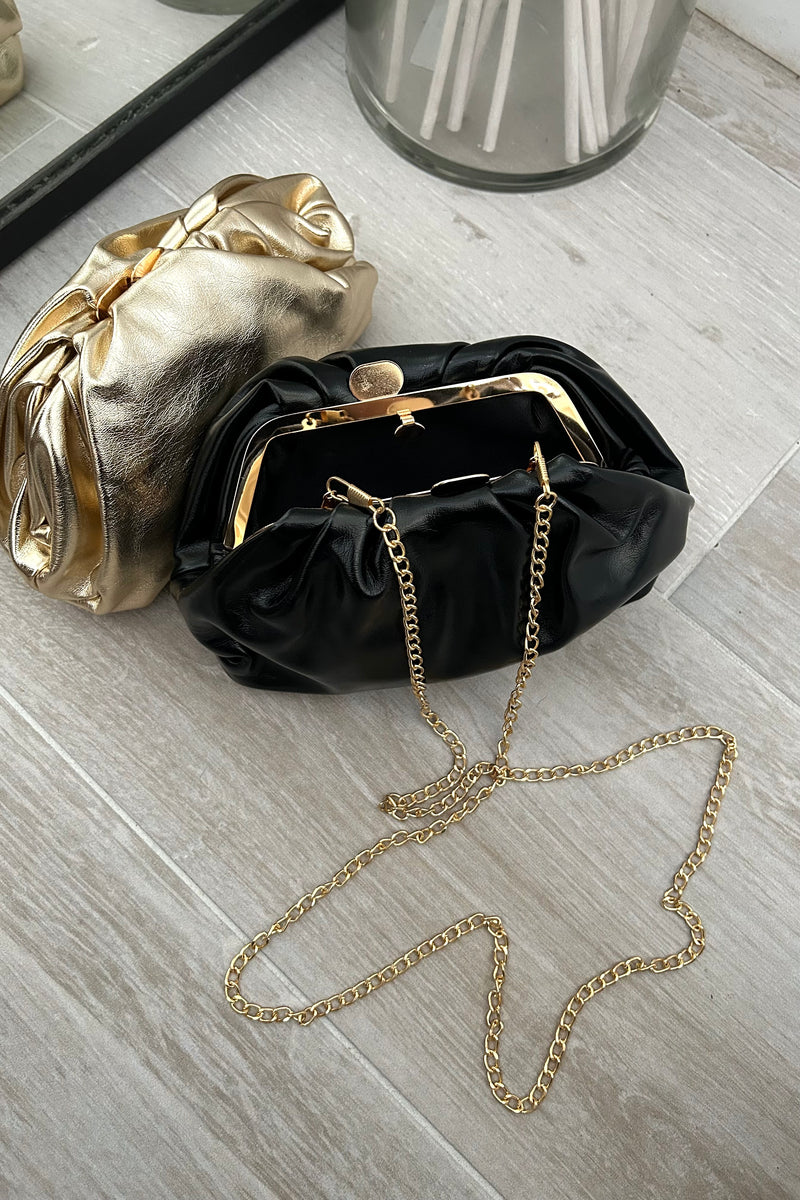 Get ready to dazzle with our Metallic Pouch Bag! This pouch-style handbag comes in both gold and black, perfect for any occasion. With a removable shoulder strap and snap buckle closure, this bag is not only stylish but also functional. Shine on!