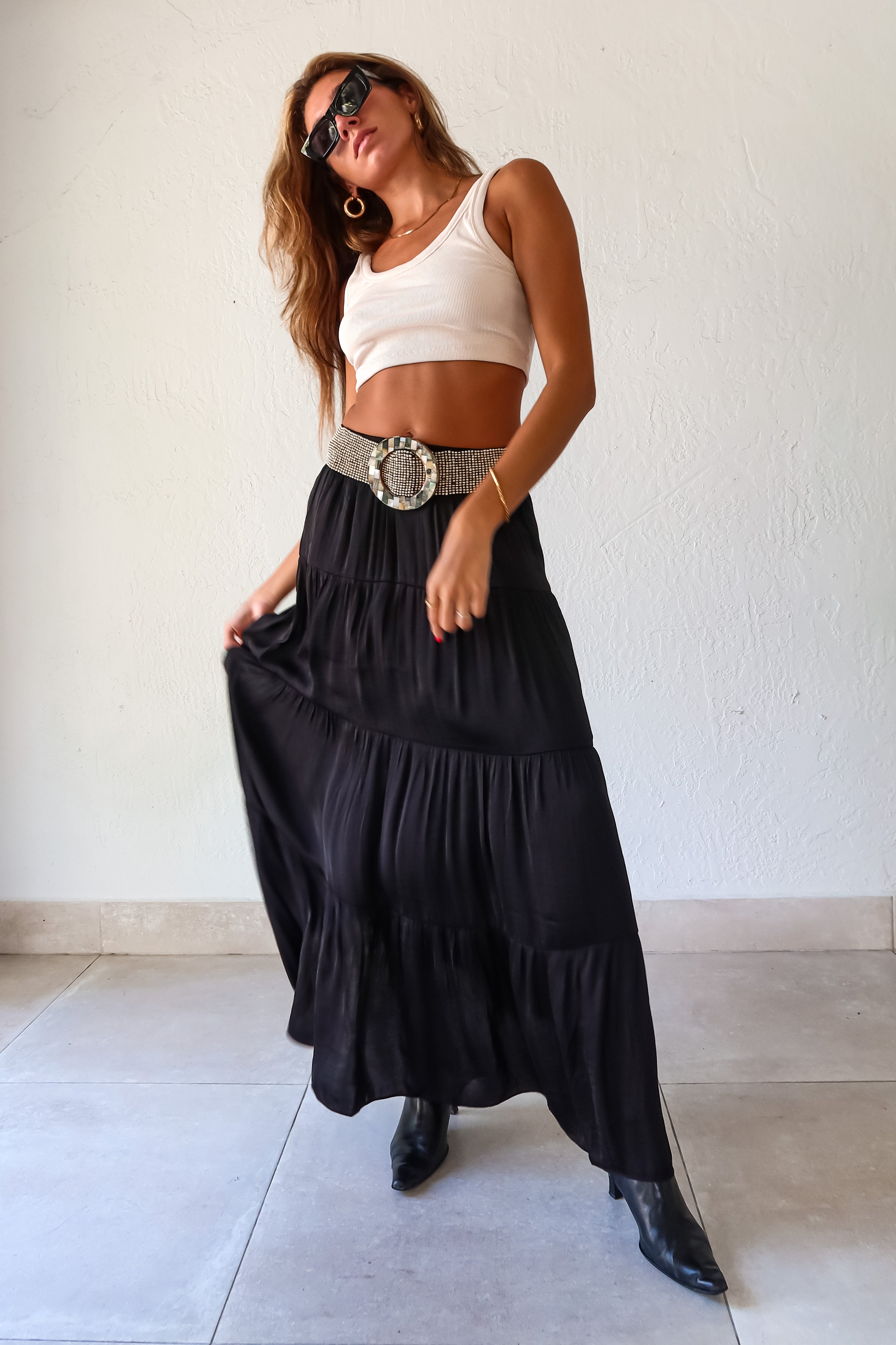  elegance and edge to your wardrobe with the Venus Satin Maxi Skirt in black! The non-stretch satin fabric flows beautifully while the elastic waistband provides a comfortable and flattering fit. Fully lined for a luxe feel 