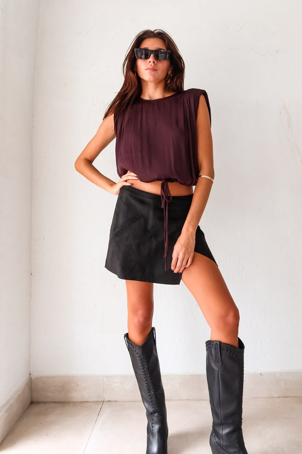 Unleash your inner rebel in the GAL SUEDE MINI SKIRT! Made with black suede, this mini skirt exudes edgy style. The overlap front button closure and back zipper closure add a touch of functionality to this statement piece. Rev up your wardrobe and rock the GAL SUEDE MINI SKIRT!