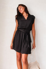 Get ready to turn heads in our Sunday Night Satin Mini Dress! This sleek black dress features a V-neck collar with shoulder padding for a structured look. The front tie sash adds a touch of femininity, while the side cargo pockets add a fun twist. With an elastic waist, you'll feel comfortable and confident all night long! (Elevate your style game with this quirky yet chic dress!)