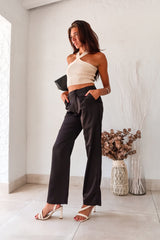 Get ready to make some bold moves with these black satin pants. The button and zipper closure, along with the elastic waist band, ensure a comfortable fit while the front pockets add functionality. Perfect for a night out on the town, these pants will have you looking stylish and feeling confident.