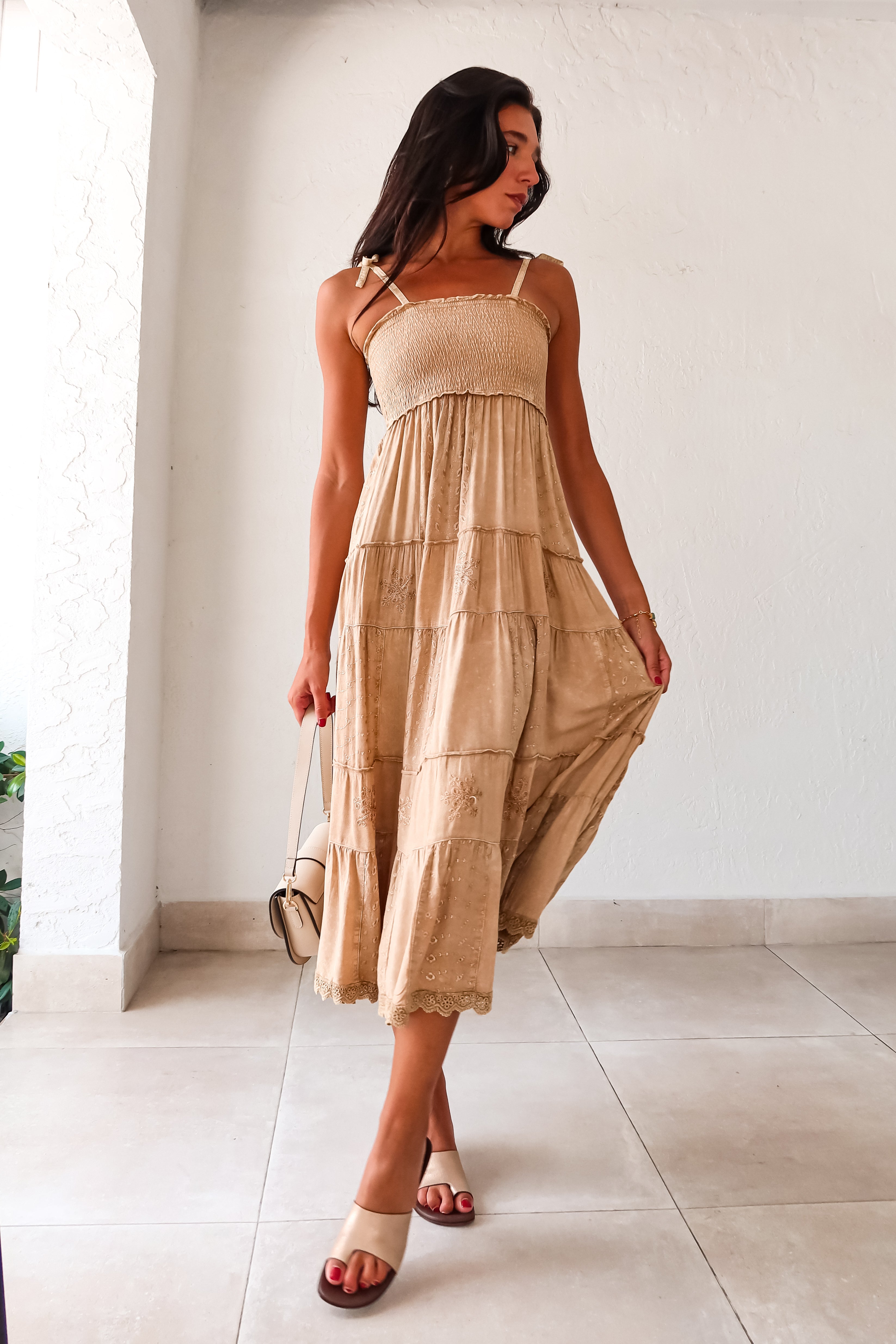  Crosby Eyelet Maxi Dress. This khaki-marigold dress features a smocked bust for the perfect fit, adjustable tie string shoulder straps, and eyelet patchwork detailing. With side pockets and a crochet trim hem, this non-stretch dress is perfect for everyday wear. 