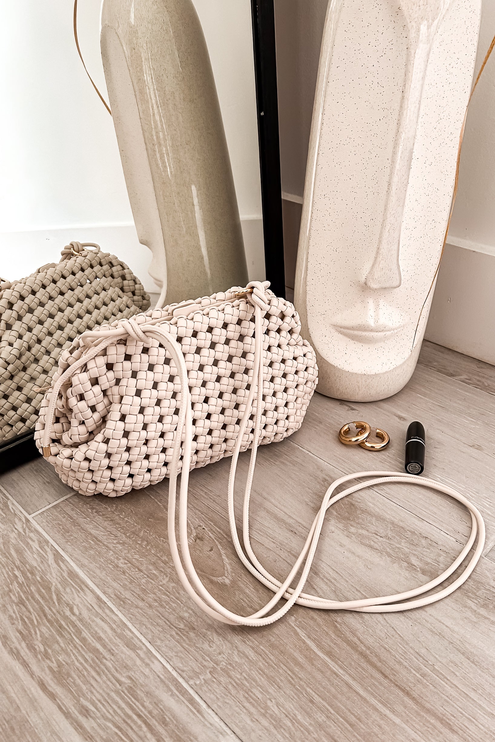 A playful twist on the classic purse, the GRECIA WOVEN PURSE is crafted from vegan leather for guilt-free style. The white woven design adds a touch of whimsy, while the magnetic closure keeps your belongings secure. With shoulder straps for easy carrying, it's a 10in length, 6.5in height, and 4.5in width of fashionable fun!