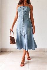 Get ready to rock a laid-back look with our Cypress Denim Midi Dress. This versatile piece features a front button down closure and adjustable shoulder straps for a customizable fit. The stretchy fabric and smocked backing provide ultimate comfort, while the chest stitch detail adds a touch of unique style. Non lined for a lightweight feel.