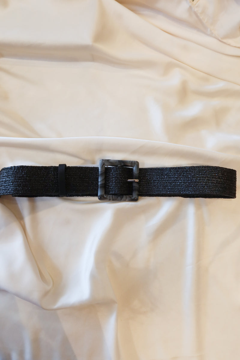 Unleash your style with our Marbled Stretch Belt! This black woven belt features a unique grey and black marble buckle and stretchy fabric for a comfortable fit. One size fits all for endless possibilities. Upgrade your wardrobe today!