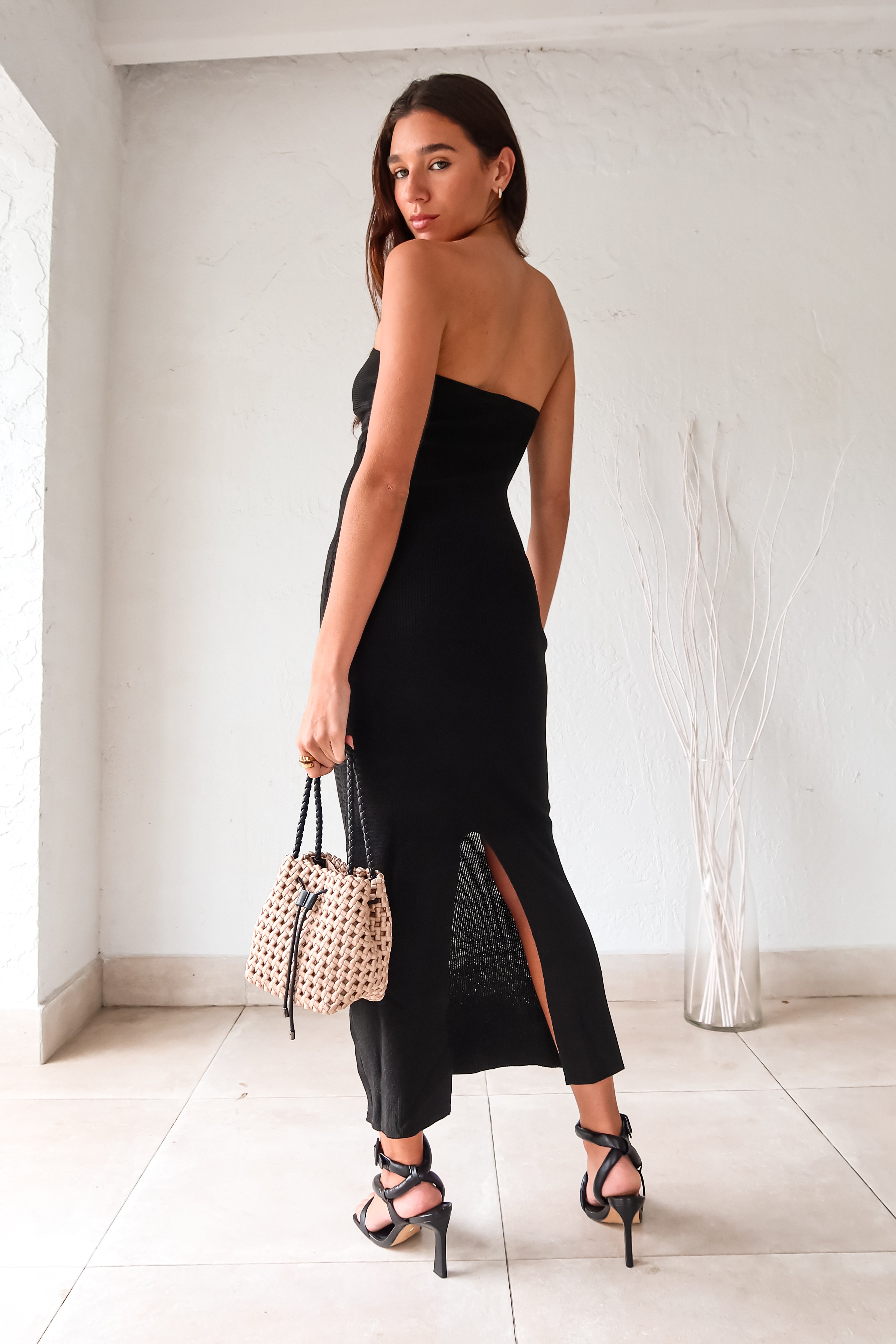 Take a quick break in this flirty and sleek black knit midi dress. The form fitting design and strapless bust overlap detail will have you looking effortlessly chic. With a back slit and stretchy fabric, this dress is both comfortable and stylish.