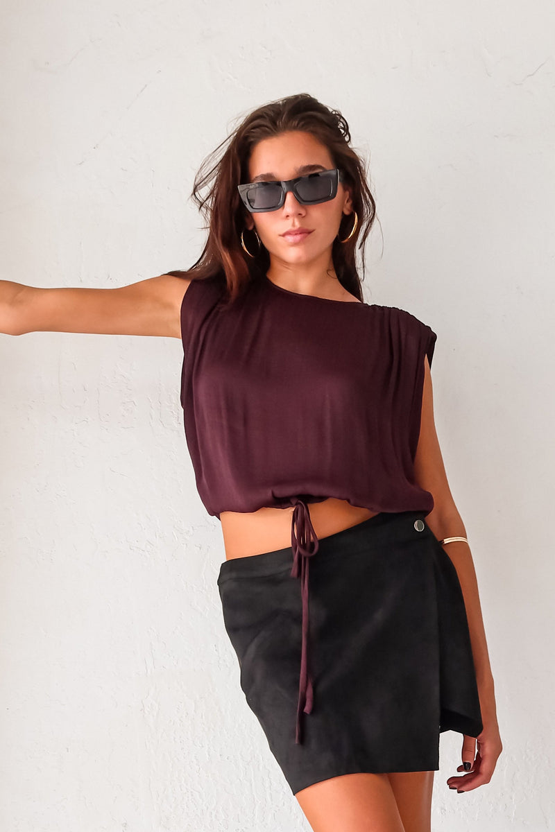 Elevate your look with our BRICKELL SATIN TOP. This sangria plum satin top features padded shoulders and an adjustable bottom hem drawstring for ultimate comfort. Complete with a back button closure and made with polyester material, hand wash cold. Size down for a perfect fit. Sofia wears an xsmall, usually a small.