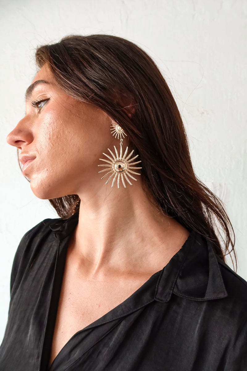 Radiate effortless style with these SUNDIAL EARRINGS. Featuring a sun design, they are sure to add a touch of playfulness to any outfit. Made of gold plated over sterling silver, they are tarnish resistant and hypoallergenic, ensuring long-lasting wear for sensitive ears. 