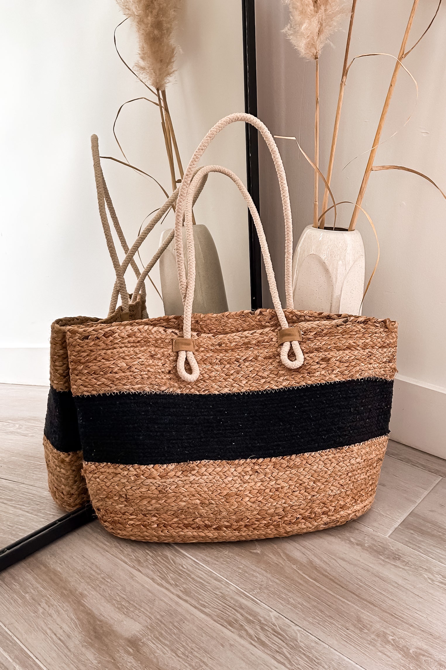 Get carried away with the LOKAL WOVEN TOTE. This spacious tote features a stylish open top design and striking rope handle detailing. Its 14in length, 12in height, and 7.5in width make it the perfect size for all your essentials. Get ready to turn heads with this brown/black beauty.